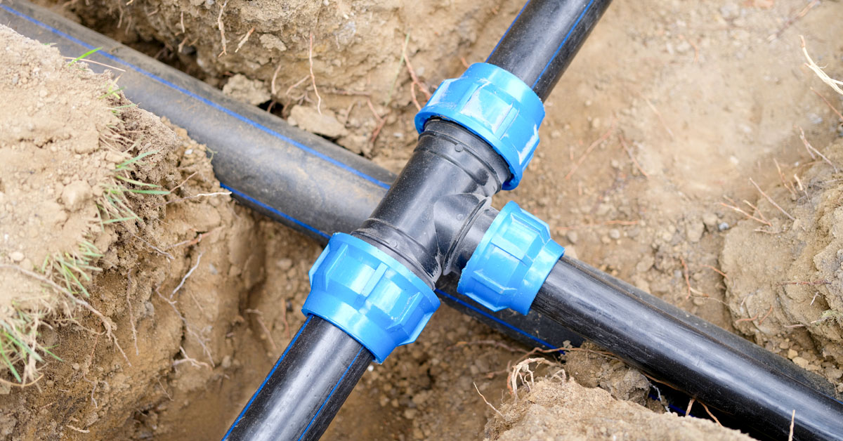 Installed PVC water pipes in trench at construction site