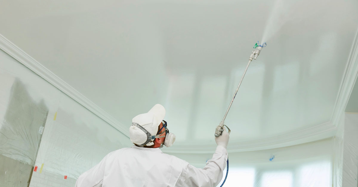 Professional painter painting the ceiling of home